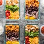 overhead shot of four glass meal prep containers with mix and match burrito bowls