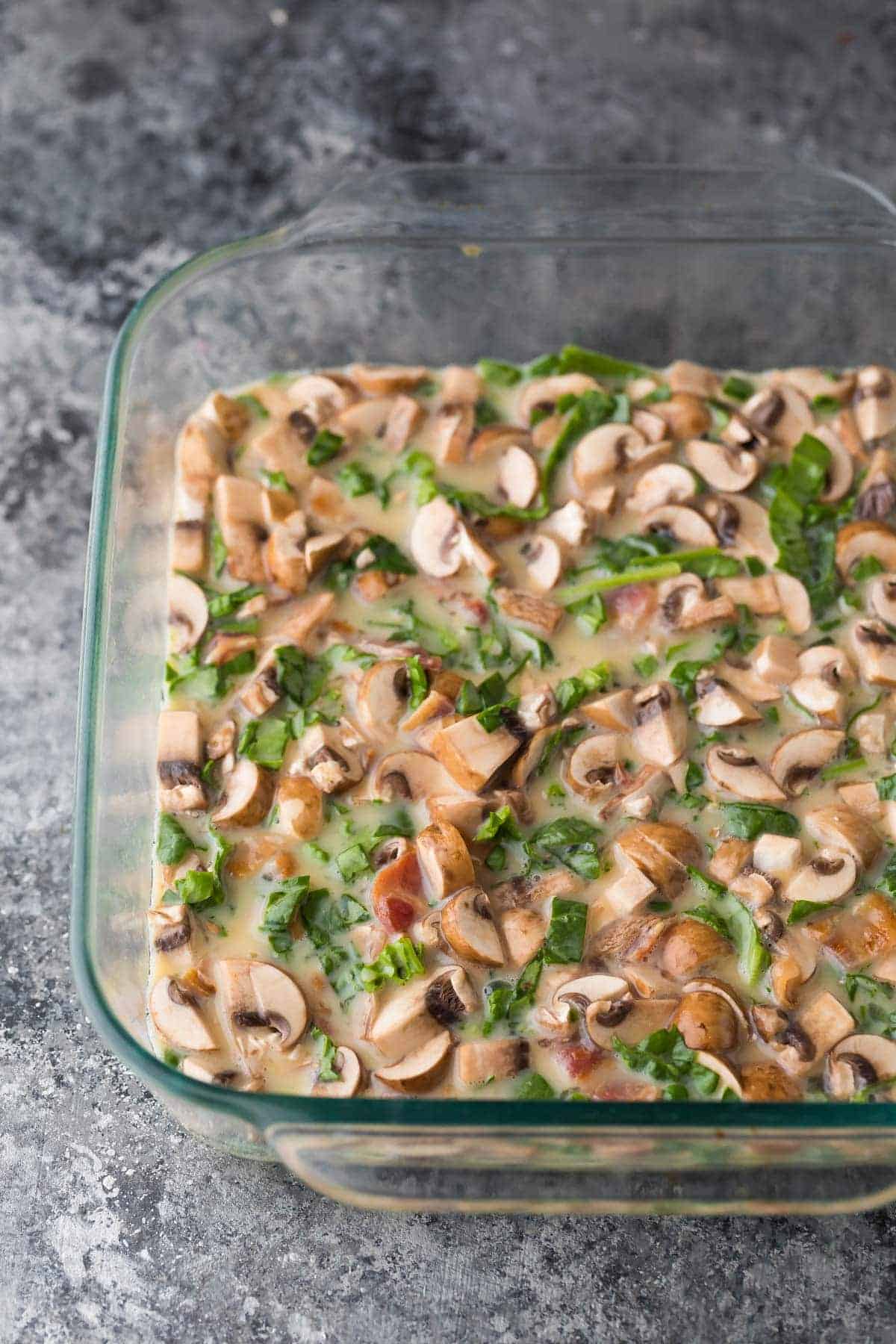 Filling for Mushroom bacon breakfast sandwiches in glass baking dish before baking