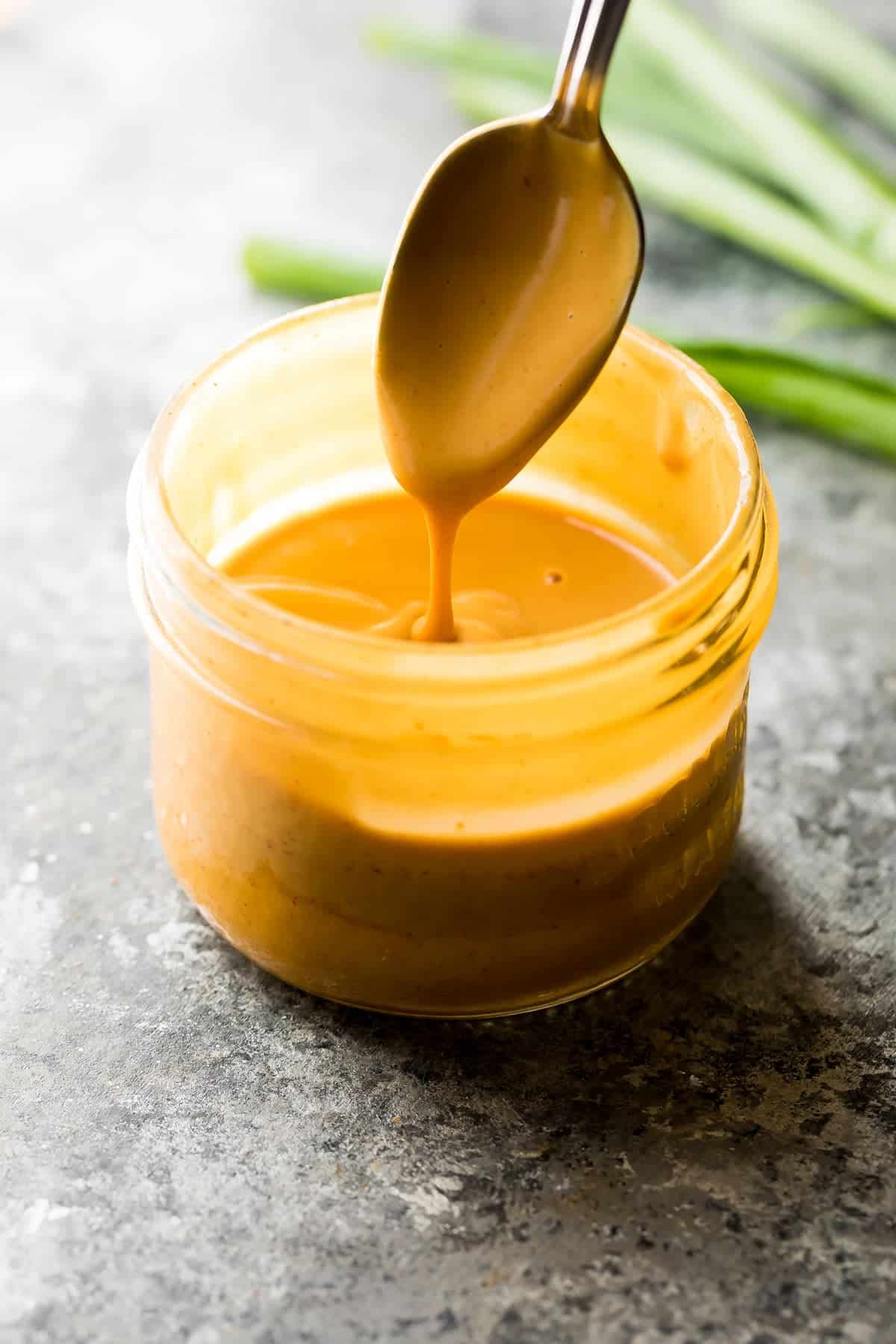 spoon dripping the peanut sauce for ground turkey lettuce wraps