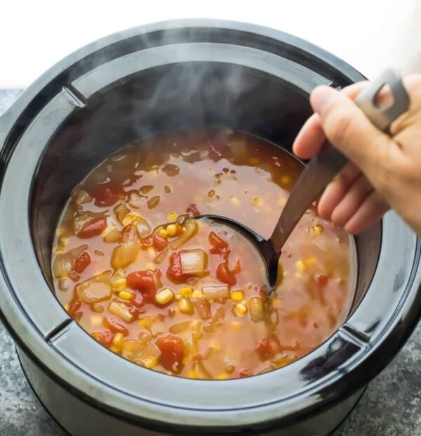 Slow cooker chickpea tortilla soup after cooking with ladle