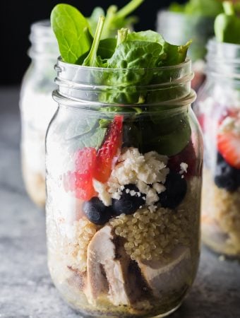 strawberry spinach quinoa jar salads in glass mason jars