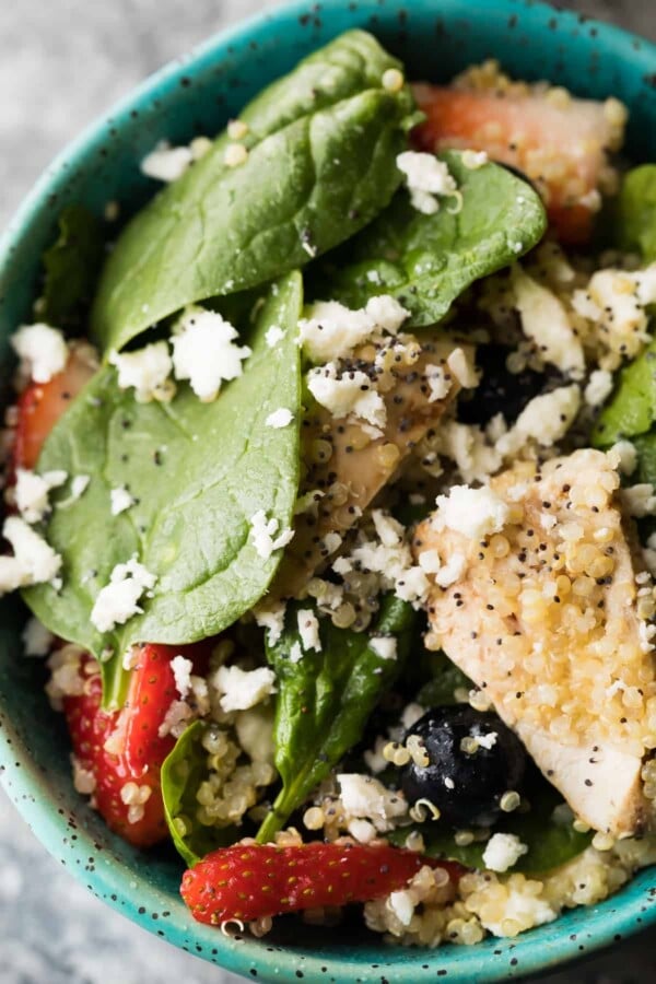 close up shot of Strawberry Spinach Quinoa Salad in blue bowl