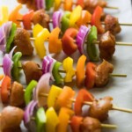 fajita chicken skewers with onion peppers and chicken in a row