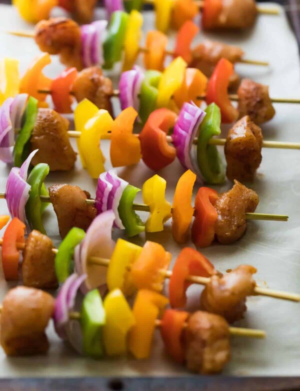 fajita chicken skewers with onion peppers and chicken in a row