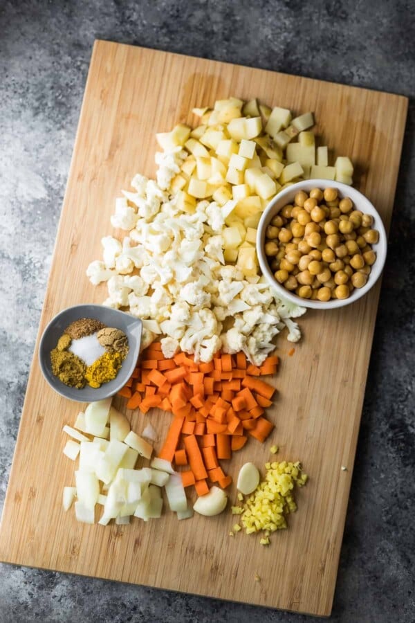 ingredients for the healthy cauliflower chickpea samosas laid out on wood cutting board