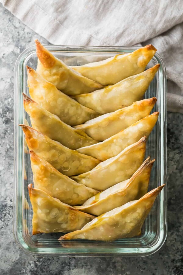 rows of healthy baked cauliflower chickpea samosas after baking in glass baking dish