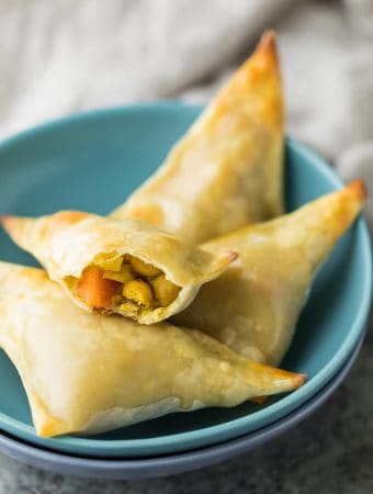 baked cauliflower chickpea samosas in a small blue bowl