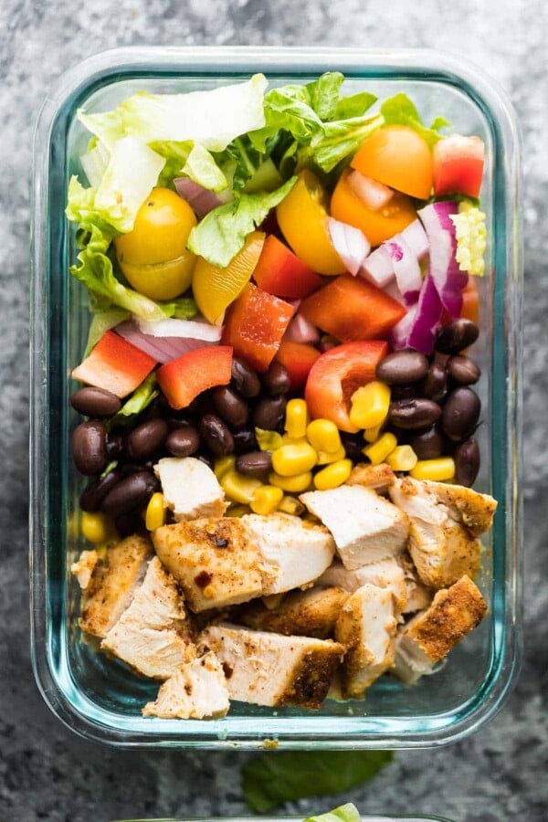 Close up view of southwestern chopped chicken salad in glass storage container