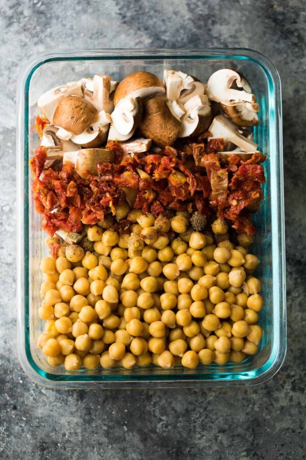 glass meal prep container filled with chickpea pasta ingredients