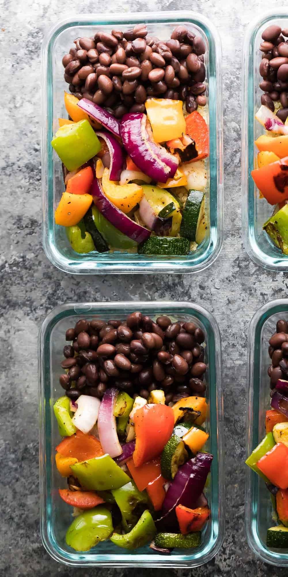 Overhead view of Grilled Veggie and Black Bean Meal Prep bowl in glass storage containers