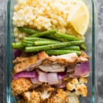 glass meal prep container with moroccan couscous bowl and green beans
