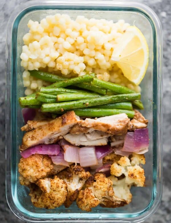 glass meal prep container with moroccan couscous bowl and green beans
