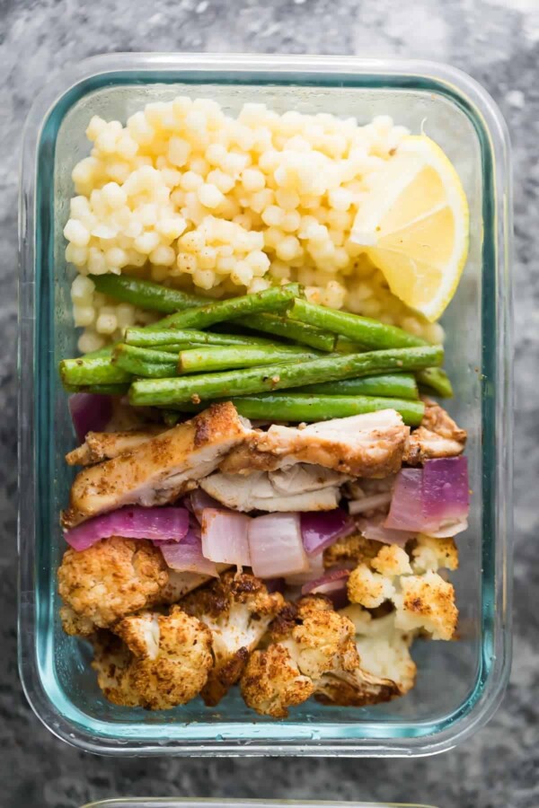 glass meal prep container with moroccan couscous bowl and green beans