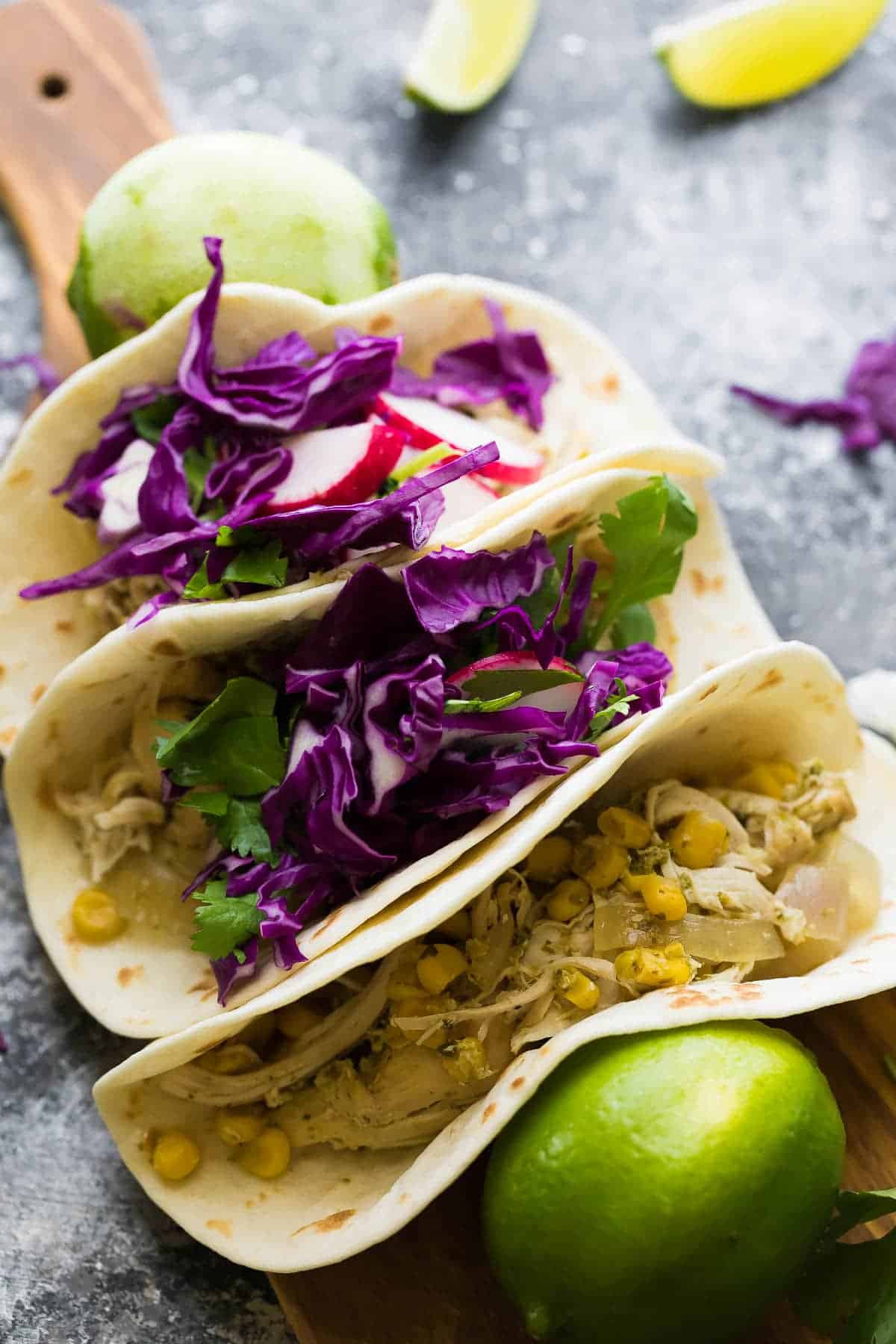 slow cooker cilantro lime chicken tacos on cutting board