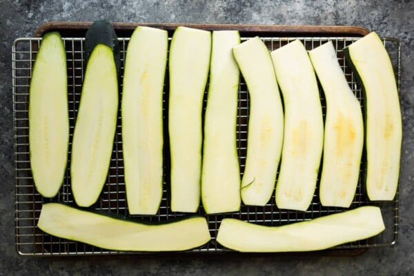 zucchini slices arranged on a wire rack prior to broiling them