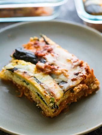 a piece of turkey zucchini lasagna on a gray plate