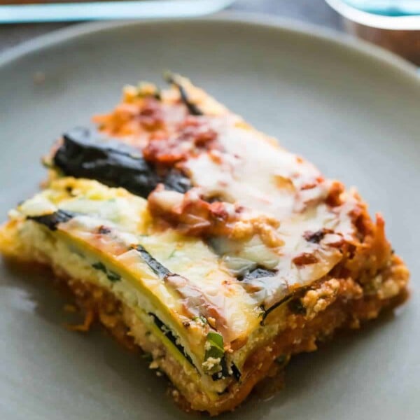 a piece of turkey zucchini lasagna on a gray plate