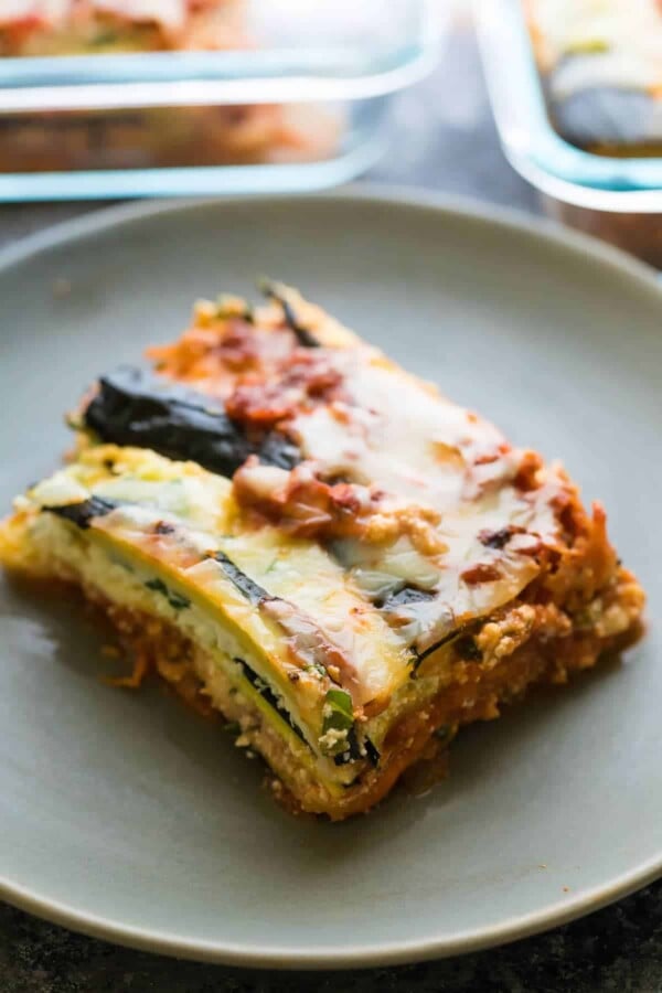 a piece of turkey zucchini lasagna on a gray plate