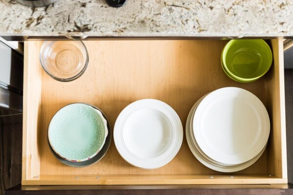 lots of bowls sitting on a wood tray on the counter