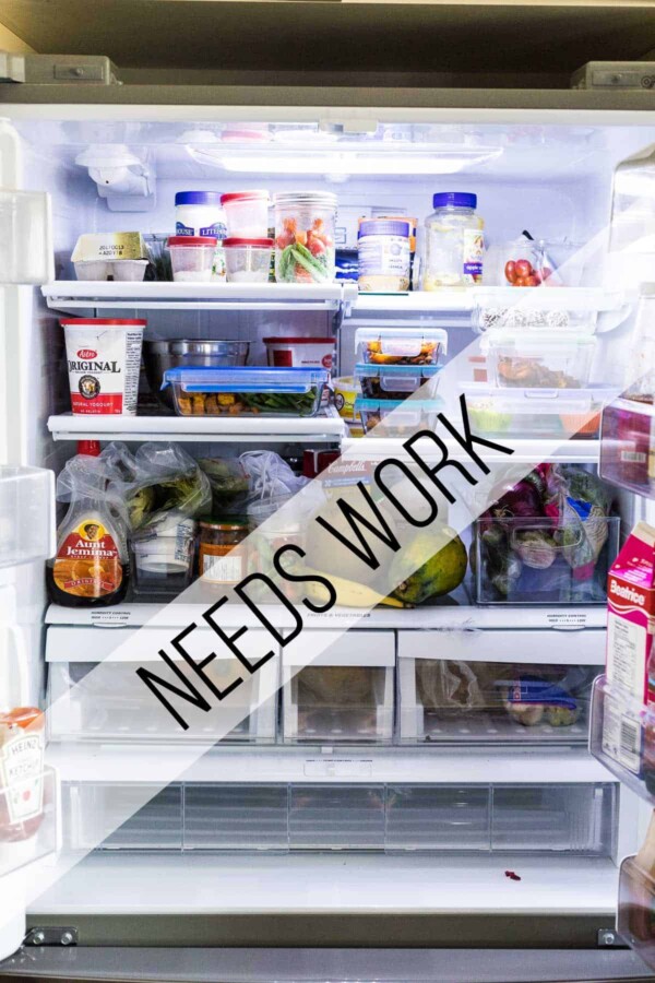 An open refrigerator filled with food and text saying needs work