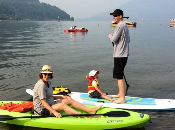 Denise and her family on paddleboards on the water