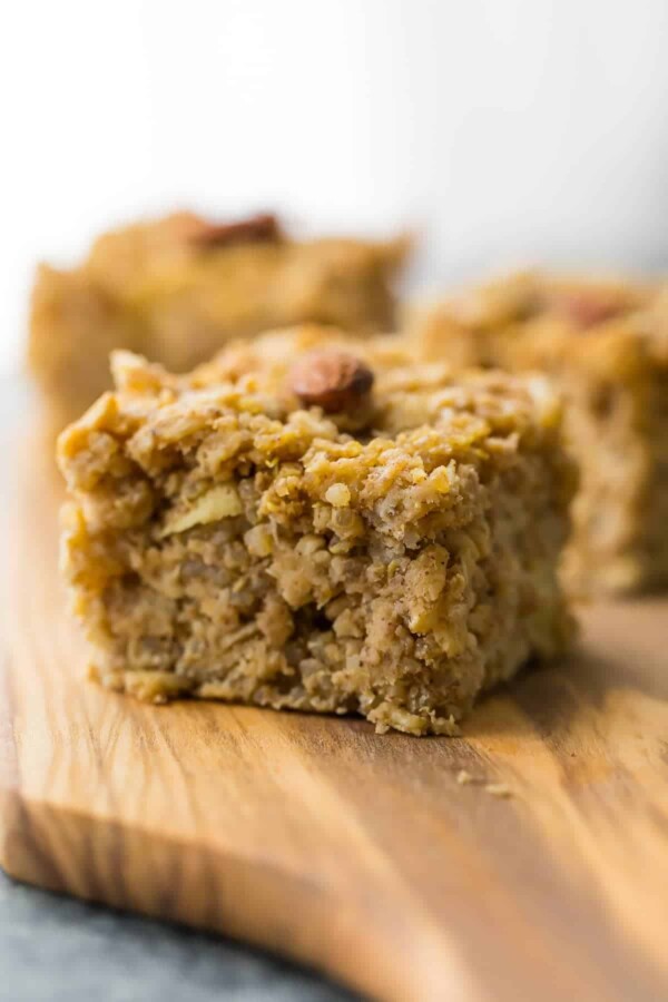 close up shot of apple quinoa breakfast bar on wood board