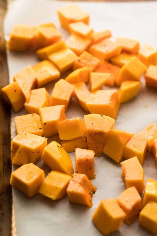 chopped butternut squash on parchment paper