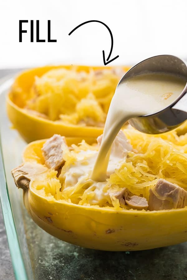 spaghetti squash being filled with lemon cream sauce