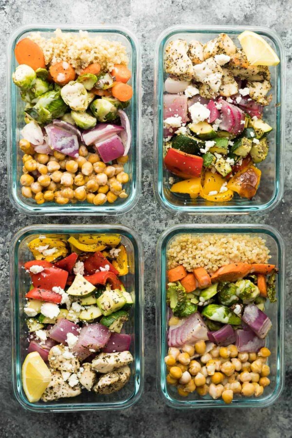 overhead image of four glass meal containers with Chickpea Buddha Bowls and Greek Chicken Wraps