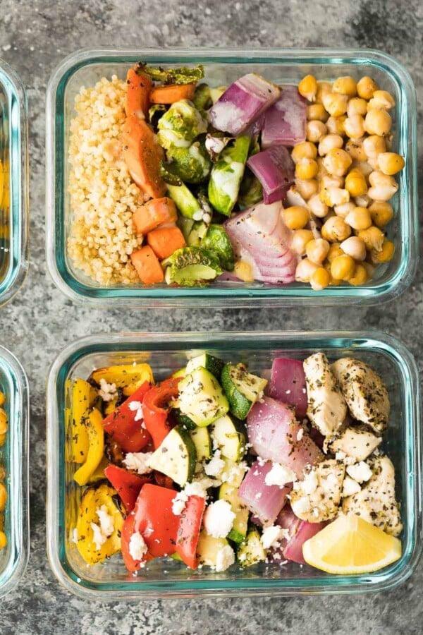 overhead view of Chickpea Buddha Bowls and Greek Chicken Wraps in glass meal prep containers