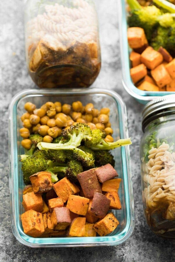 Overhead view of sweet potato, chickpea, broccoli bowl in glass meal prep container