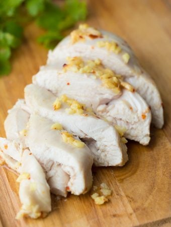 sliced ginger and lemon chicken on wood cutting board