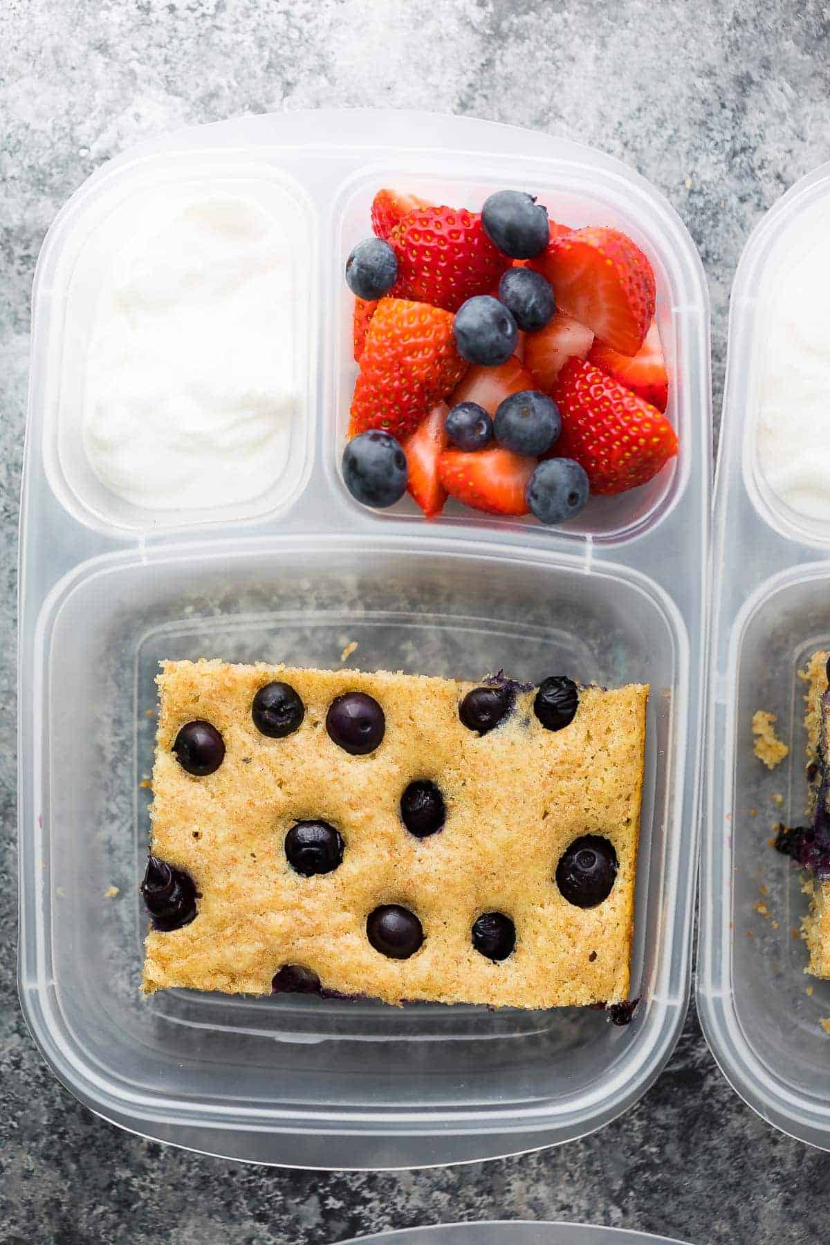 protein pancake in a meal prep container with side of fresh fruit