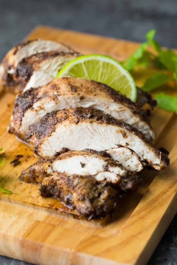 sliced chicken cooked in jerk marinade on cutting board
