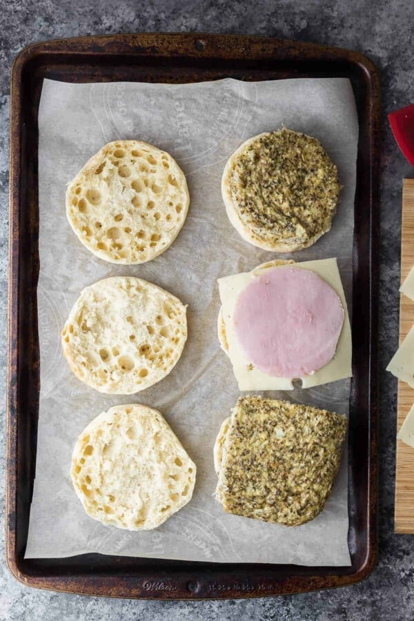 cauliflower herb breakfast sandwiches being assembled on sheet pan