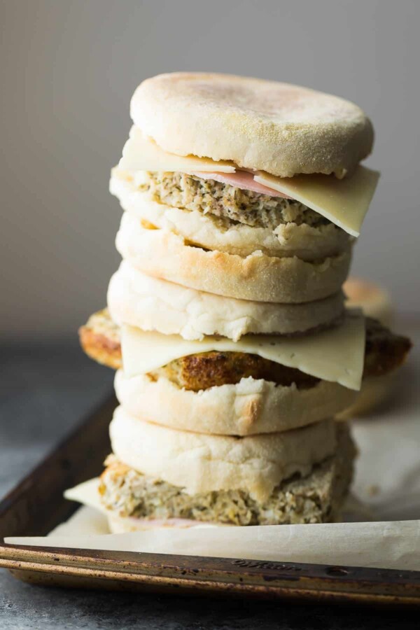 Stack of cauliflower herb freezer breakfast sandwiches on sheet pan