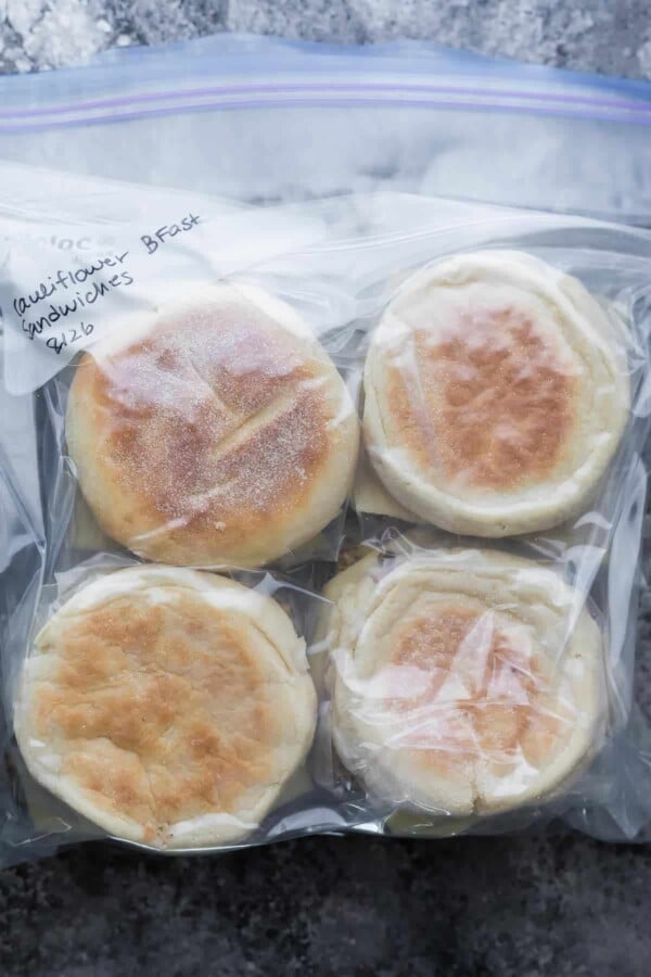 Four cauliflower herb breakfast sandwiches in freezer bag ready to be frozen