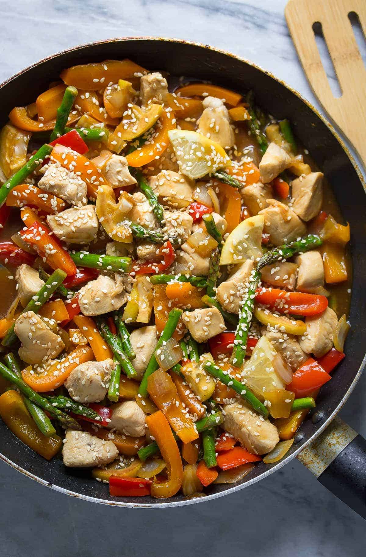 overhead shot of lemon sesame chicken stir fry in black skillet