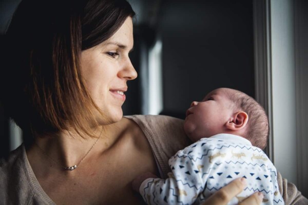 Denise holding a small baby boy