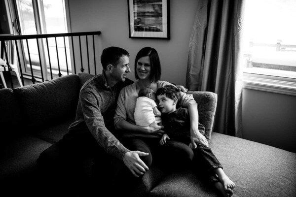 Denise sitting on the couch with her family