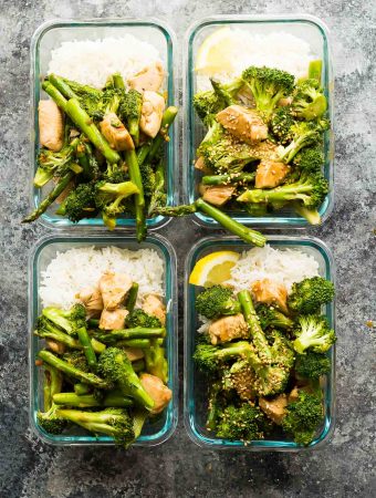 overhead shot of four glass meal prep containers with vegetable and rice stir fry
