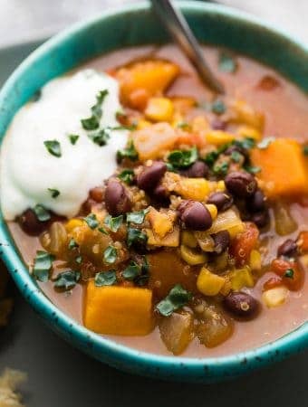 close up shot of black bean quinoa sweet potato stew in blue bowl