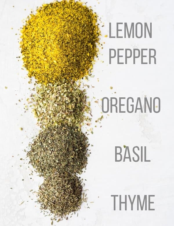 ingredients lined up for lemon herb seasoning with labels on white background