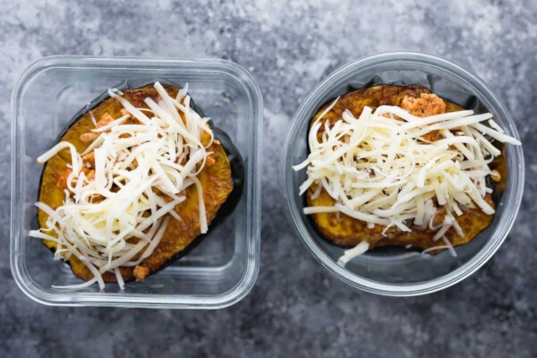 Overhead shot of Two stuffed acorn squash in glass containers