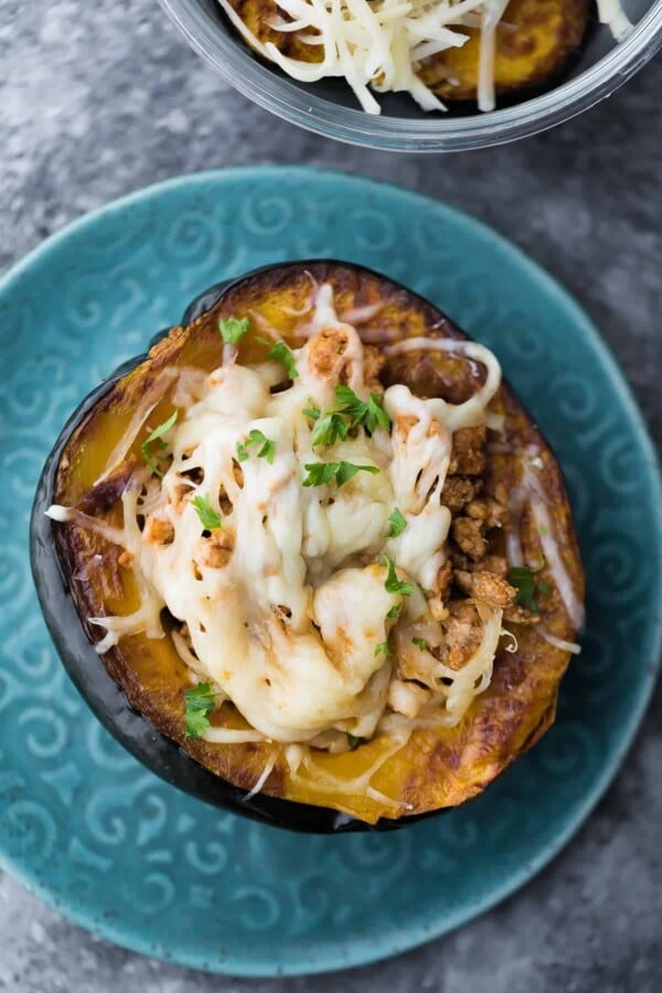 Overhead view of taco stuffed acorn squash with cheese