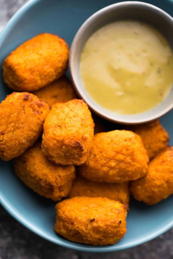 Crispy Air Fryer Sweet Potato Tots on blue plate with dipping sauce