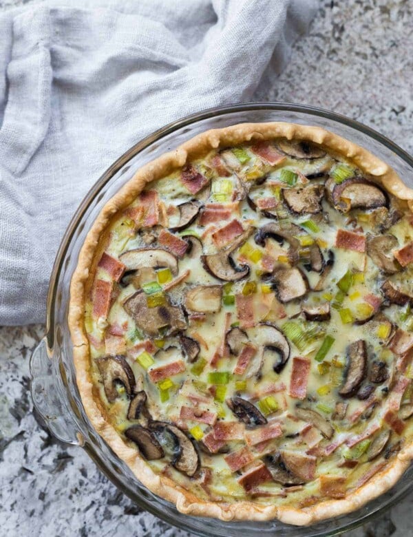 overhead shot of back mushroom dairy free quiche on gray counter