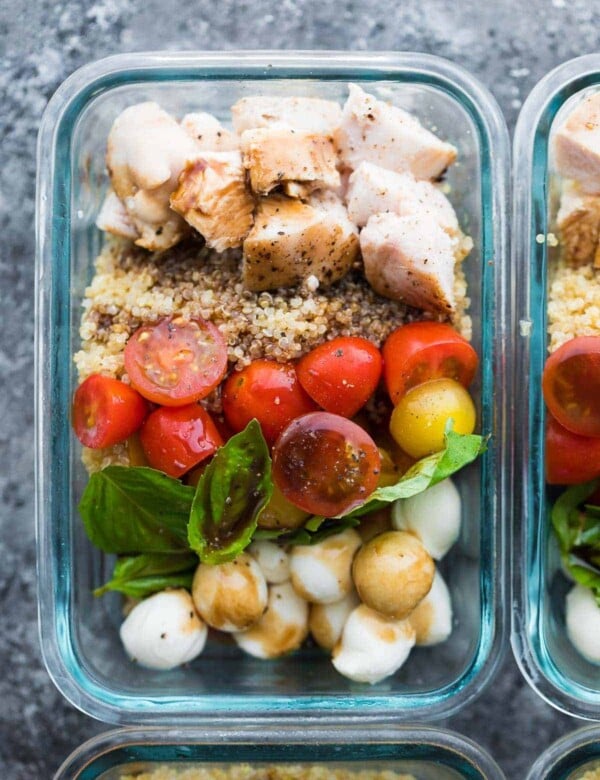 close up shot of caprese chicken salad meal prep bowl in glass container