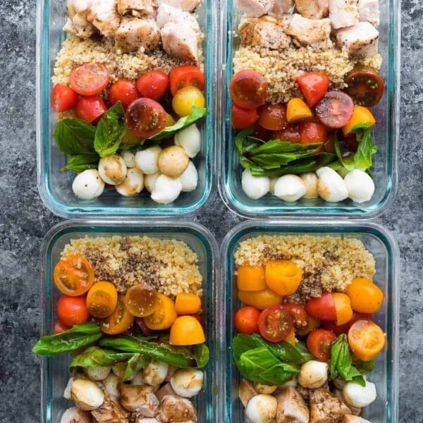 overhead shot of caprese chicken salad meal prep bowls on gray counter