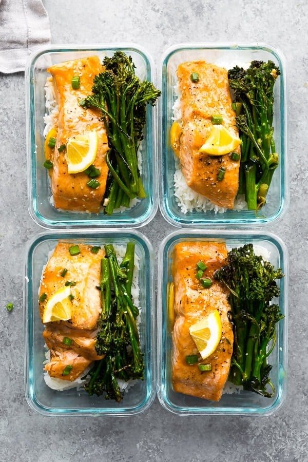  overhead shot of Sheet Pan Honey Lemon Salmon & Broccolini in four meal prep containers
